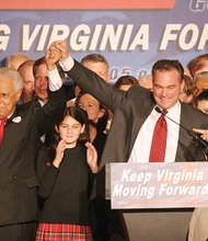 Gov.-elect Kaine signals his victory on election night 2005 with former Gov. L. Douglas Wilder. 