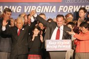 Gov.-elect Kaine signals his victory on election night 2005 with former Gov. L. Douglas Wilder. 