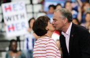 Sen. Kaine gives his wife, Anne Holton, a kiss in response to her glowing introduction at Monday’s rally.