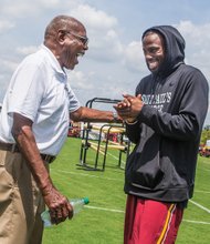 NFL cornerback Greg Toler, right, is reunited with Coach Willard Bailey Monday at the Washington team’s training camp in Richmond. Coach Bailey gave Toler his start in college ball at St. Paul’s College in Lawrenceville.