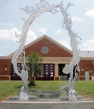 Cityscape // This new public sculpture, titled “Estuary,” now stands behind Fire Station No. 17 at 2211 Semmes Ave.  Richmond Mayor Dwight C. Jones led the July 21 unveiling of the 10-foot-tall, stainless steel piece. The sculptor is Ross Caudill of Brooklyn, N.Y., who earned his master’s in fine arts at Virginia Commonwealth University. When the station was built in 2012, 1 percent of the $4.6 million construction cost was set aside to pay for public art to go with it. Mr. Caudill was paid $34,103, and another $5,000 was spent to install his work. However, his sculpture is largely invisible to people and traffic passing the station on Semmes. It is actually located outside the station property in adjacent Canoe Run Park, where it overlooks people playing and exercising. The city park is at 20th Street and Riverside Drive. 