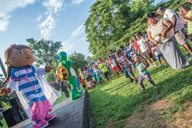 Crime-fighting power in community // Two-year-old Summer Sky, above right in green shirt, and 5-year-old Aiden Cox, in red, white and blue shirt, dance Tuesday evening at a National Night Out celebration in North Side,