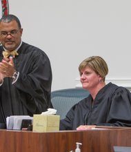 New Judge Mary Elizabeth Langer receives applause from the chief judge of the Richmond Circuit Court, C.N. Jenkins Jr. She joined him on the bench during a ceremony last Friday in which she was officially installed as a judge of the Richmond Juvenile and Domestic Relations District Court.  