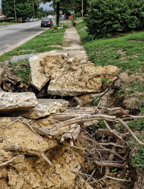 Cityscape // City contractors removed huge branches and most of the tree’s trunk, but to Ms. Woods’ dismay, left this mess. It’s opportunity time for the city to show it can complete the job of removing the tree and replacing the heavily damaged sidewalk.     