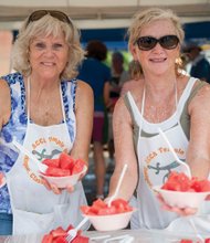 Fruity fun in Carytown // With the weekend temperatures soaring, thou- sands of people enjoyed a cool summer favorite — watermelon — at Sunday’s 33rd Annual Carytown Watermelon Festival.
Several blocks of West Cary Street were trans- formed into a large street party filled with the sounds of bands, entertainers and food.
Right, Connie Chisholm, left, and Pat McKenzie with the ACCA Temple Shriners serve bowls of the refreshing fruit.
Proceeds from the watermelon sales benefit the Shriners Hospitals for Children, which provides care for youngsters without charge. Organizers said several Richmond area children are being helped at the hospitals, the closest of which is located in Greenville, S.C.