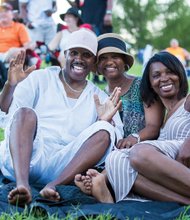 Fans brought blankets and chairs and spread out on the lush lawns at Maymont to soak in the music. From left, Dennis and Sabreen Friday lounge with Stella Rose