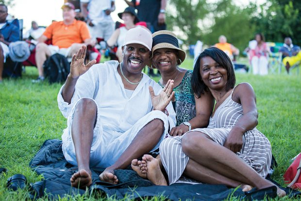 Fans brought blankets and chairs and spread out on the lush lawns at Maymont to soak in the music. From left, Dennis and Sabreen Friday lounge with Stella Rose