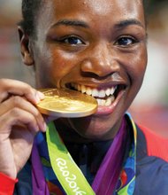 Claressa Shields enjoys the taste of victory after beating Nouchka Fontijn of the Netherlands to win gold and retain her middleweight title at the 2016 Olympic games in Rio de Janeiro. 