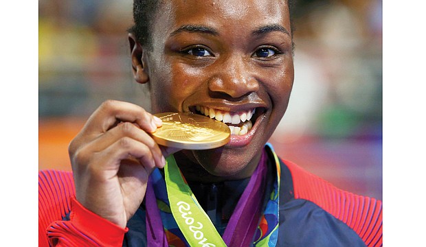 Claressa Shields enjoys the taste of victory after beating Nouchka Fontijn of the Netherlands to win gold and retain her middleweight title at the 2016 Olympic games in Rio de Janeiro. 