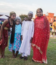 Its a family Reunion //Right, Nahla Elzubair, 10; left, Salma, 6; and Ahmed Haroun, 9;
and Leena Salin, 11, who were with family at the Sudanese table, walk
around the festival at Abner Clay Park in Jackson Ward.