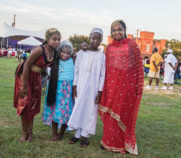Its a family Reunion //Right, Nahla Elzubair, 10; left, Salma, 6; and Ahmed Haroun, 9;
and Leena Salin, 11, who were with family at the Sudanese table, walk
around the festival at Abner Clay Park in Jackson Ward.
