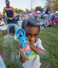 Down home fun //
Two-year-old Mali Bey creates bubbles and his own fun
last Saturday at the Down Home Family Reunion at Abner
Clay Park in Jackson Ward. Families came together to
enjoy music, dance, stories, food and shopping at the
annual event. 