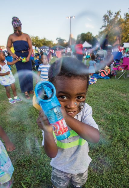 Down home fun //
Two-year-old Mali Bey creates bubbles and his own fun
last Saturday at the Down Home Family Reunion at Abner
Clay Park in Jackson Ward. Families came together to
enjoy music, dance, stories, food and shopping at the
annual event. 