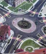 New Roundabout in North Side // This aerial view shows the new roundabout that has replaced the traffic lights at the Six Points intersection in Highland Park. Above, Mayor Dwight C. Jones officially opened the $1.2 million traffic circle Tuesday after more than eight months of construction. Federal funds paid for 90 percent of the work at the crossroads of Brookland Park Boulevard, Meadowbridge Road and Second and Dill avenues. This is one of a series of roundabouts the city has developed in recent years, primarily in the East End. 