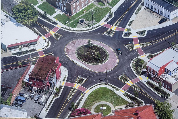 New Roundabout in North Side // This aerial view shows the new roundabout that has replaced the traffic lights at the Six Points intersection in Highland Park. Above, Mayor Dwight C. Jones officially opened the $1.2 million traffic circle Tuesday after more than eight months of construction. Federal funds paid for 90 percent of the work at the crossroads of Brookland Park Boulevard, Meadowbridge Road and Second and Dill avenues. This is one of a series of roundabouts the city has developed in recent years, primarily in the East End. 