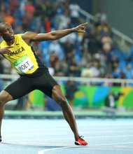 Usain Bolt strikes his signature pose following his gold medal run in the men’s 200-meter Olympic competition in Rio de Janeiro. 