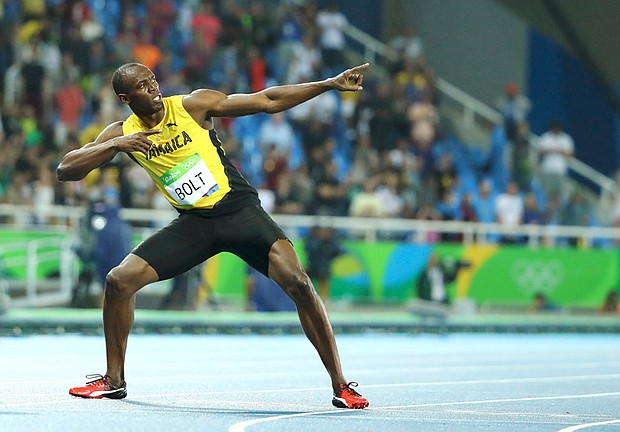 Usain Bolt strikes his signature pose following his gold medal run in the men’s 200-meter Olympic competition in Rio de Janeiro. 