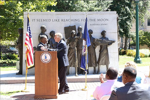 After delivering the introduction, Eric Branch turns the podium over to Gov. Terry
McAuliffe for the announcement that 13,000 people once again will be able to vote.
Location: The Virginia Civil Rights Memorial on Capitol Square in Downtown. The
governor restored Mr. Branch’s voting rights last year. A Chesterfield County resident
who once served time for breaking-and-entering, Mr. Branch now owns and operates a
lawn care service.