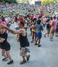 Moving to the beat // The event, one of the summer highlights
of the 60th Festival of the Arts,
drew crowds of people who enjoyed
the sounds of several musical groups.
Rather than sitting and tapping their feet,
many people jumped up and danced to
the rhythms.