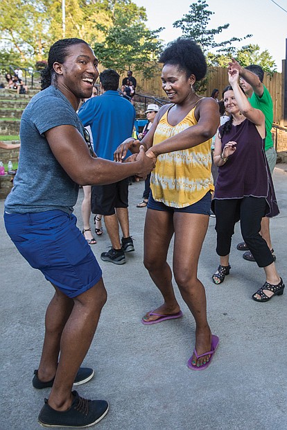 Moving to the beat //  David and Cierra Lacks find the
beat and move their feet last Saturday
at the 9th Annual Latin Jazz and Salsa
Festival at Richmond’s Dogwood Dell.