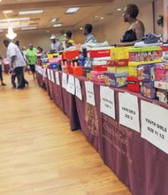 Kicks for kids // Below, volunteers wait to assist the students in a mock shoe store created in the fellowship hall. Excited youngsters could be fitted for the appropriate shoe size before selecting from a wide assortment.