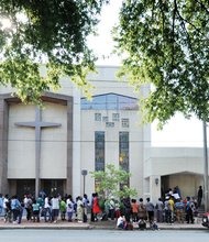 New kicks for kids // Dozens of people line the sidewalk last Saturday for the 4th Annual Back to School Shoe Drive at Cedar Street Baptist Church of God in Church Hill. The church
gave away hundreds of pairs of new shoes to youngsters who will be returning to classrooms on Tuesday, Sept. 6. 