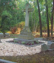 Volunteers have spruced up the burial site of banking pioneer Maggie L. Walker, whose headstone sits to the left of the large cross in Evergreen Cemetery. The three headstones, right, mark the graves of her husband, Armistead Walker Jr., and their two sons.