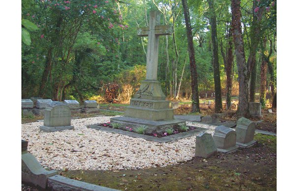 Volunteers have spruced up the burial site of banking pioneer Maggie L. Walker, whose headstone sits to the left of the large cross in Evergreen Cemetery. The three headstones, right, mark the graves of her husband, Armistead Walker Jr., and their two sons.