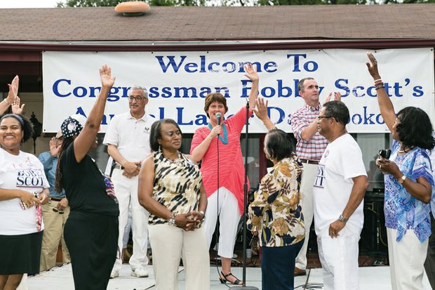 Flanked by U.S. Rep. Robert C. “Bobby” Scott, left, and Lt. Gov. Ralph Northam, Anne Holton, wife of Democratic vice presidential
candidate Tim Kaine, engages the crowd as she stumps for her husband and presidential nominee Hillary Clinton at Rep. Scott’s
Annual Labor Day Cookout. In front, from left, are Delegate Marcia Price of Newport News, Rep. Scott’s niece; state Sen. Mamie
Locke of Hampton, chair of the Virginia Legislative Black Caucus; Lisa Lucas-Burke, a candidate for Portsmouth City Council; former
Newport News Delegate Flora Crittenden; Newport News Mayor McKinley Price, Rep. Scott’s brother-in-law and the father of Delegate
Price; and Chesapeake City Councilwoman Ella P. Ward.