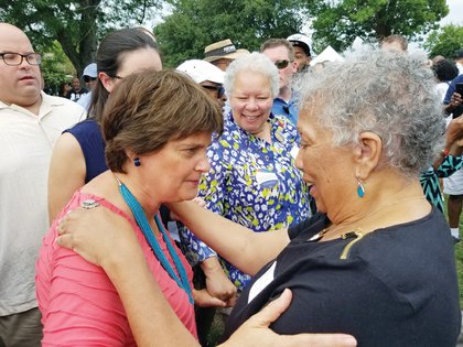 Anne Holton, left, and Free Press President-Publisher Jean P. Boone greet one another and pause to talk at the annual Labor Day Cookout.