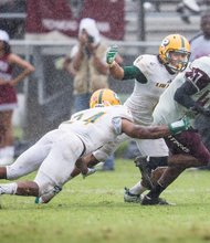 Virginia Union University wide receiver Lavatiae Kelly tries to avoid a takedown by Long Island University-Post’s defensive players during last Saturday’s season opener at Hovey Field. The VUU Panthers lost the matchup 14-12.