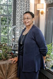 Viola O. Baskerville, the former state secretary of administration, poses in the study of her Ginter Park home, Pineapple Acre, which was selected as this year’s Richmond Symphony Orchestra League Designer House. 