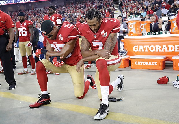 San Francisco 49ers safety Eric Reid, left, and quarterback Colin Kaepernick kneel during the national anthem during the opening of the NFL team’s game Monday night against the Los Angeles Rams.