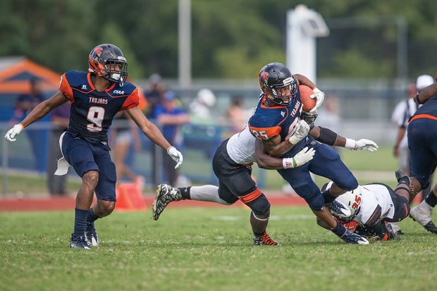 Defensive players rush in to tackle Virginia State University junior Trenton Cannon, part of the Trojans’ relentless overland offense that resulted in a VSU 24-10 victory last Saturday over Tusculum College.
