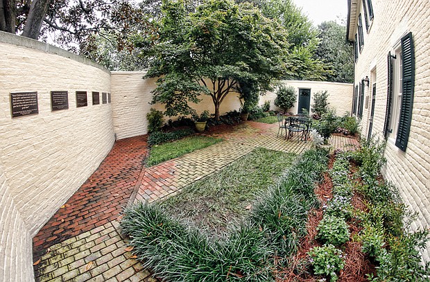 The new Valentine-Jackson Memorial Garden enshrines the memories and letters of the Valentine and Jackson families, enslaved people who were brought to the Virginia Executive Mansion in 1837 by Gov. David Campbell of Abingdon. The garden sits outside the mansion’s old slave quarters that were renovated in 1999 and now serve as guest bedrooms. Plaques around the garden wall contain excerpts from the letters.