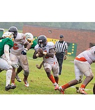 Virginia State University junior Tyquante Simms rushes
for a gain as the Trojans beat Kentucky State University
last Saturday 20-7 in Frankfort, Ky.