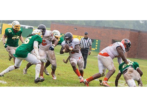 Virginia State University junior Tyquante Simms rushes
for a gain as the Trojans beat Kentucky State University
last Saturday 20-7 in Frankfort, Ky.