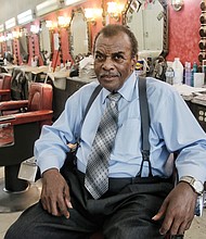 Franklin Harvey Sr., 83, reflects at Harvey’s Progressive Barber Shop, home of the Afro Master comb, at 22 E. Broad St. The shop is the last of two he owned and operated in Downtown for more than 40 years.    