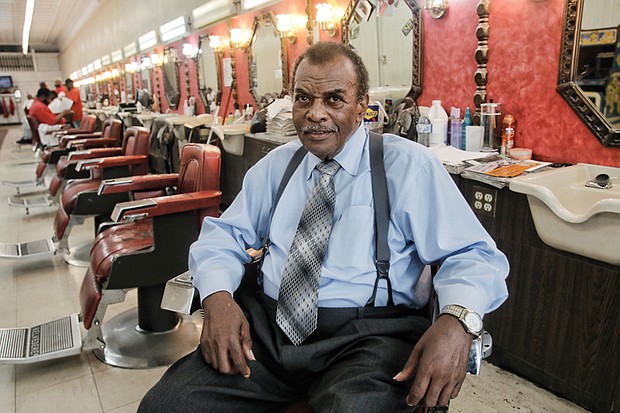 Franklin Harvey Sr., 83, reflects at Harvey’s Progressive Barber Shop, home of the Afro Master comb, at 22 E. Broad St. The shop is the last of two he owned and operated in Downtown for more than 40 years.    