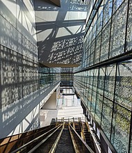 Light pours through the exterior metal panels, illuminating
the interior of the new National Museum of African
American History and Culture in Washington. It is the first
LEED Gold certified museum on the National Mall.