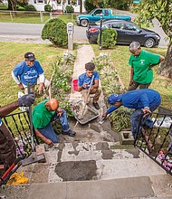 Below, volunteers, from left, Randy
Thomas, James Nelson, Harold Hockaday, Derrick Isler,
Richard Burwell, Judith Wansley and Charlie Booker work
to repair the steps and walkway outside the Highland
Springs home of an elderly person.