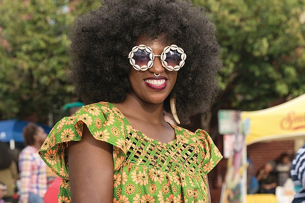 Fun on 2nd Street // Andrea Daughtry, right,  shows off her cowry shell glasses near the booths where vendors sold a variety of merchandise and food.
The event is sponsored by Venture Richmond.