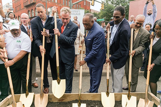 This group proudly prepares to turn the ground Sept. 29 to officially launch development of the Downtown plaza where a statue to Richmond pioneering businesswoman Maggie L. Walker will stand. Wielding the shovels are, from left: J. Maurice Hopkins of the Mag- gie Walker High School Class of 1965; City Councilman Chris A. Hilbert; Mrs. Walker’s great-great-grandson, Diallo Brooks of Washington; Gov. Terry McAuliffe; Mayor Dwight C. Jones; Mrs. Walker’s great-grandson, Johnny Mickens III of Richmond; Melvin Jones Jr., who helped spearhead the statue effort; and Selena Cuffee-Glenn, Richmond’s chief administrative officer. Location: Broad and Adams streets. The city is investing nearly $1 million to create the statue and plaza to honor Mrs. Walker, who, in 1903, became the first African-American woman to found and head a bank in the United States.