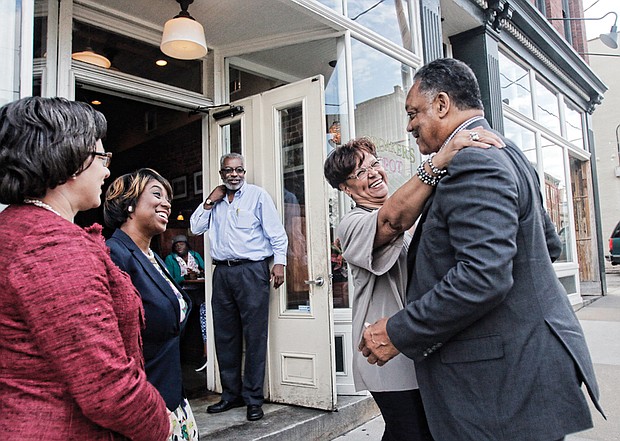 Richmond City Council Vice President Ellen F. Robertson embraces civil rights icon the Rev. Jesse Jackson outside of Croaker’s Spot on Hull Street in South Side. Ms. Robertson, Richmond Delegate Jennifer L. McClellan, left, and Petersburg Delegate Lashrecse D. Aird were among the group that dined and talked politics with Rev. Jackson on Tuesday as he campaigned in Richmond for Democratic presidential candidate Hillary Clinton. Croaker’s Spot general manager Ralph Fields looks on. 
