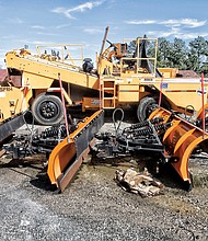 This photo shows a line of snowplows and the large Rosco gravel chip spreader that the Richmond Department of Public Works has left parked for years. Location: The department’s Hopkins Road compound in South Side. 