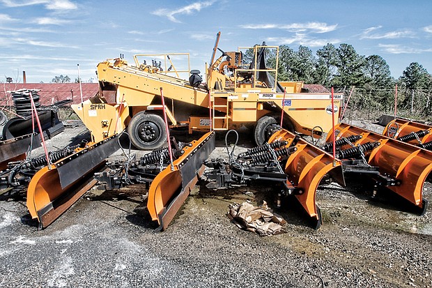 This photo shows a line of snowplows and the large Rosco gravel chip spreader that the Richmond Department of Public Works has left parked for years. Location: The department’s Hopkins Road compound in South Side. 