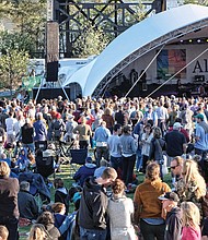 Concert-goers enjoy the sunshine and cool weather on Sunday at the Altria stage at the Richmond Folk Festival.