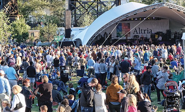 Concert-goers enjoy the sunshine and cool weather on Sunday at the Altria stage at the Richmond Folk Festival.