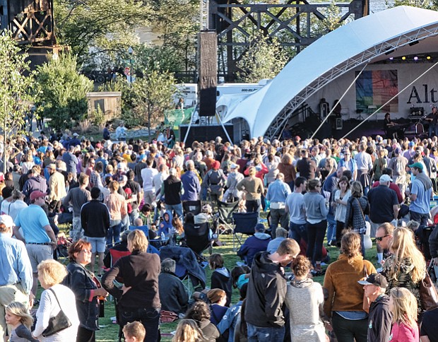 Concert-goers enjoy the sunshine and cool weather on Sunday at the Altria stage at the Richmond Folk Festival.