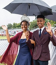 Miss VUU LaRae Gilliard and Mr. VUU Alphonso Ross wave to the crowd as they make the rounds at the football game. 
